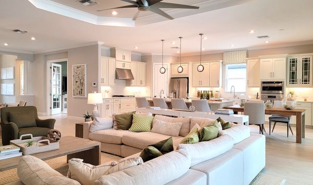 bright open living room with sectional sofa and kitchen