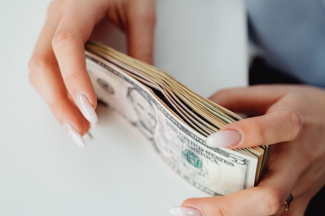hands counting a stack of cash